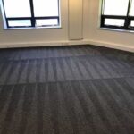 This is a photo of a grey office carpet that has just been professionally steam cleaned works carried out by Beddington Carpet Cleaning