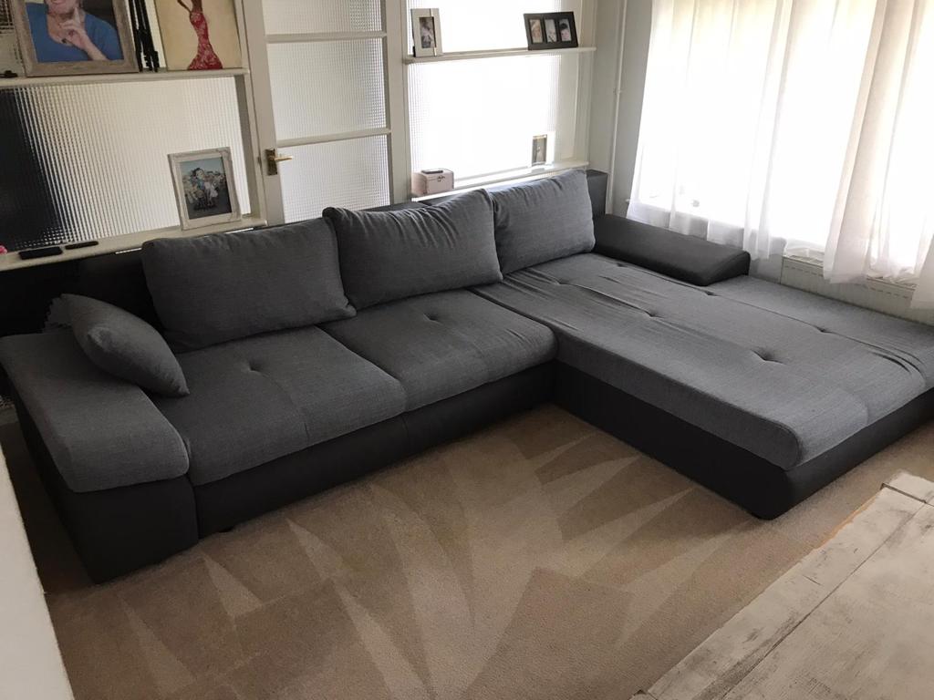 This is a photo of a grey L shape sofa that has been professionally steam cleaned, also the beige carpets have been steam cleaned too works carried out by Beddington Carpet Cleaning