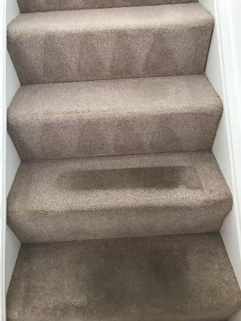 this is a photo of a staircase with beige carpets that is in the process of being cleaned works carried out by Beddington Carpet Cleaning